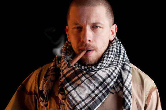 Army officer smoking the victory cigar, dark background