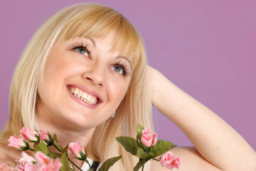 Portrait of a beautiful blonde Caucasian happy lady with flowers