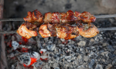 cook shish kebab on skewer under hot coal