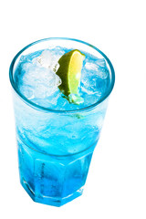 glass of blue cocktail with lime on white background