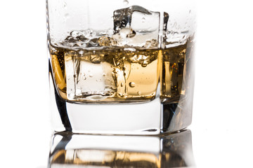 Pouring whiskey on the rocks close-up