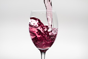 Flush of wine falling into a wineglass