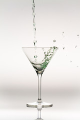 Splash of liquor inside a cocktail glass