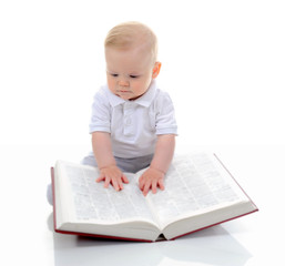 Little boy reads a big book