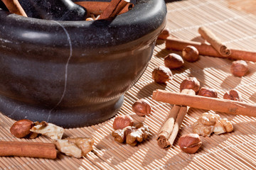 Nuts and cinnamon sticks on a bamboo mat