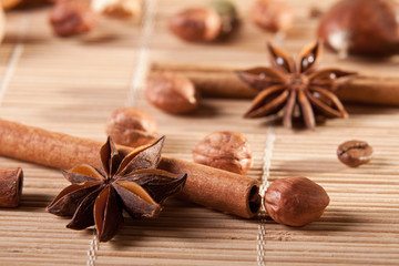 Anise, cinnamon and nuts on a bamboo mat