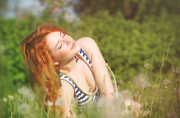 beautiful happy young woman in the park on a warm summer day