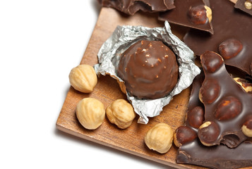Chocolate bar and candy with hazlenut, isolated on white
