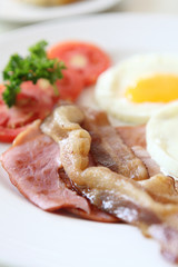 Breakfast with bacon , fried egg and orange juice