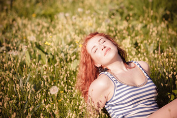 beautiful happy young woman in the park on a warm summer day