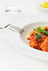 Cod fish Seafood with tomato, herbs on white tablecloth