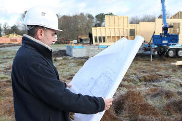 Construction worker examining a blueprint
