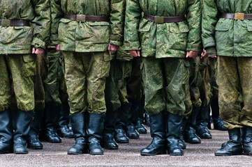 Soldiers stand in formation legs only