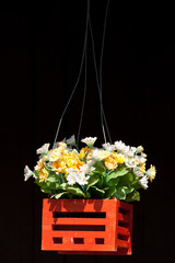 Artificial flowers in wood basket