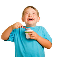 Happy smiling young child eating yogurt
