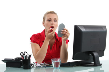 Woman making up on her workplace