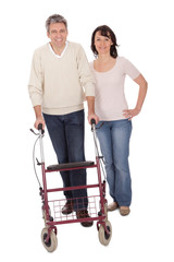 Mature couple using walking aide