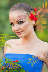 A young woman with a body-art on the face