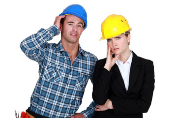 female architect looking annoyed and foreman by her side