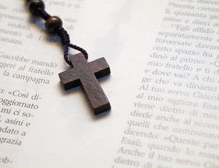 Old Wooden Rosary isolated on holy Bible