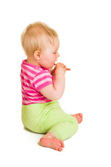 Infant baby learning to eat a biscuit