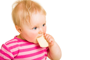 Infant baby learning to eat a biscuit