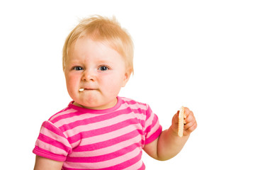 Infant baby learning to eat a biscuit