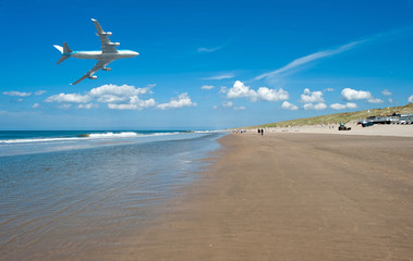 Fototapeta na wymiar Aircraft flying over a beach