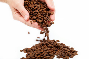 Naklejka premium Female hand with coffee beans, isolated on white.