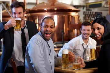 Happy fans watching TV in pub cheering