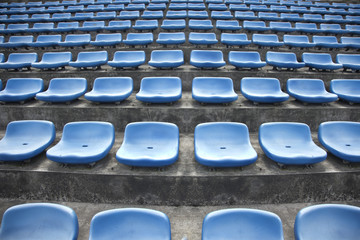 blue ordered rubber seats in a sports track field