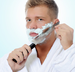 Young man shaving