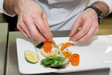 Obraz na płótnie Canvas Chef is arranging delicious vegetarian dish