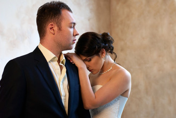 bride and groom standing in empty room