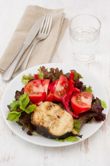 grilled fish with salad on the white plate
