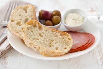 bread with ham, olives and sauce