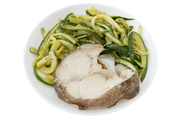 boiled fish with vegetables in white plate
