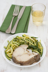 boiled fish with vegetables and glass of wine