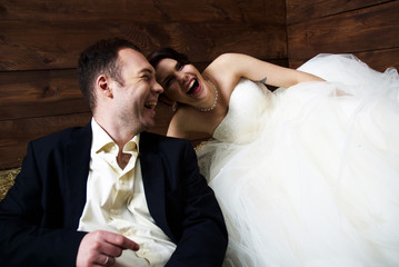 couple in their wedding clothes in barn laughing © dmitry_zubarev
