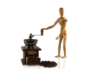wooden man grind coffee on a old machine