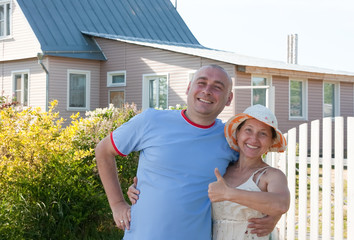 man and   woman in front of  house