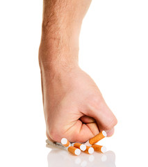 Man’s fist crushing cigarettes