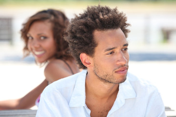 Woman looking at her pensive boyfriend