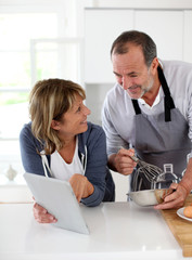 Senior couple having fun in home kitchen