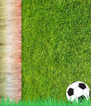 Football soccer on grass and wood background