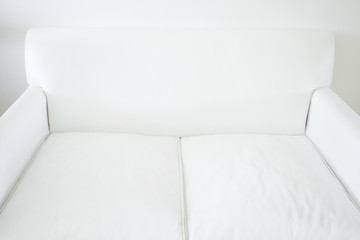 white sofa on a white wall  background