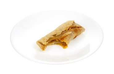 Beef and bean chimichanga on plate bitten