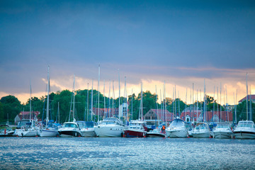 Boats in the harbor of Mikolajki at sunset