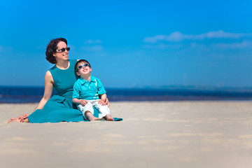 Fototapeta premium Mother and her cute little son at tropical beach