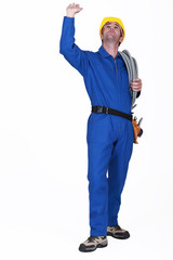 Electrician touching ceiling